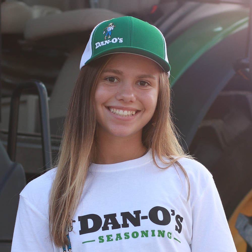A woman wearing a Green Dan-O’s Original Logo Hat