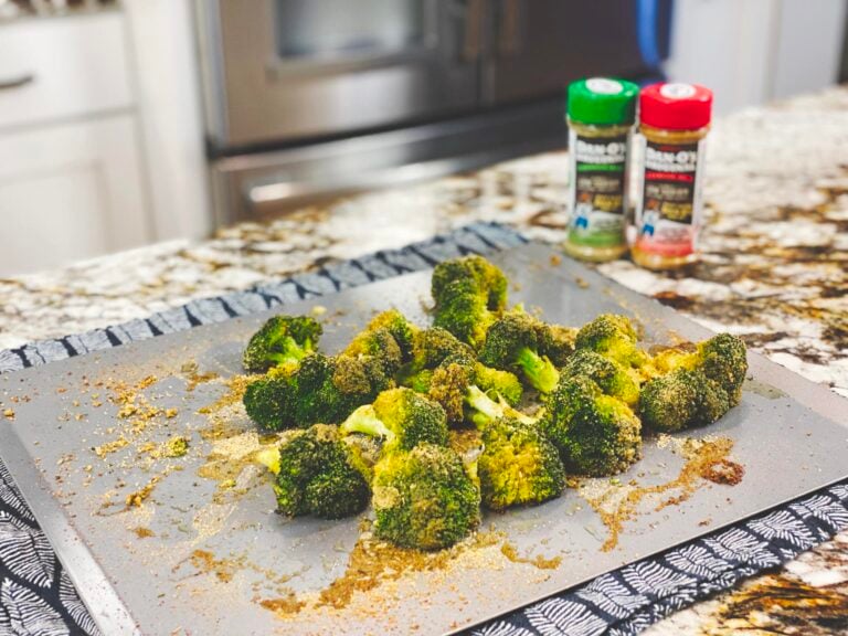 Image of baked broccoli with danos seasoning in the background