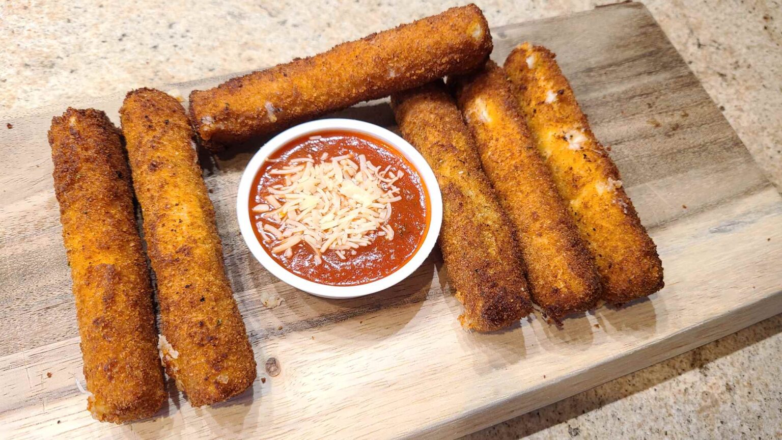 Homemade mozzarella sticks with marinara ready to eat